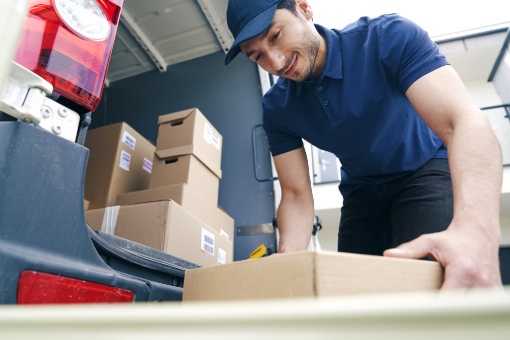 Courier unloading packages on the hand truck