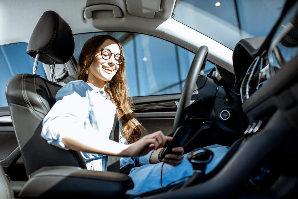 Woman with phone in the car
