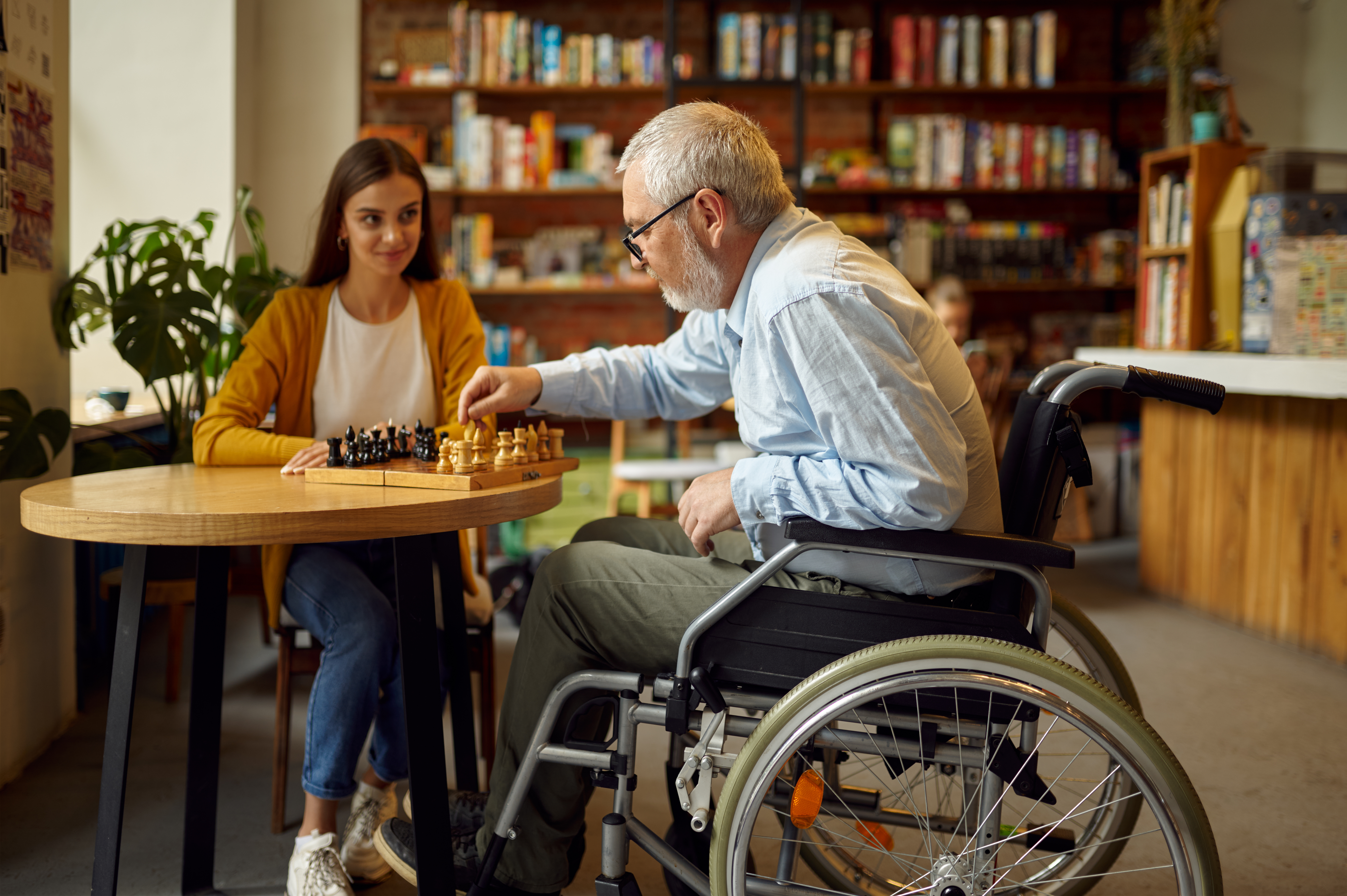 Disabled grandfather and granddaughter play chess